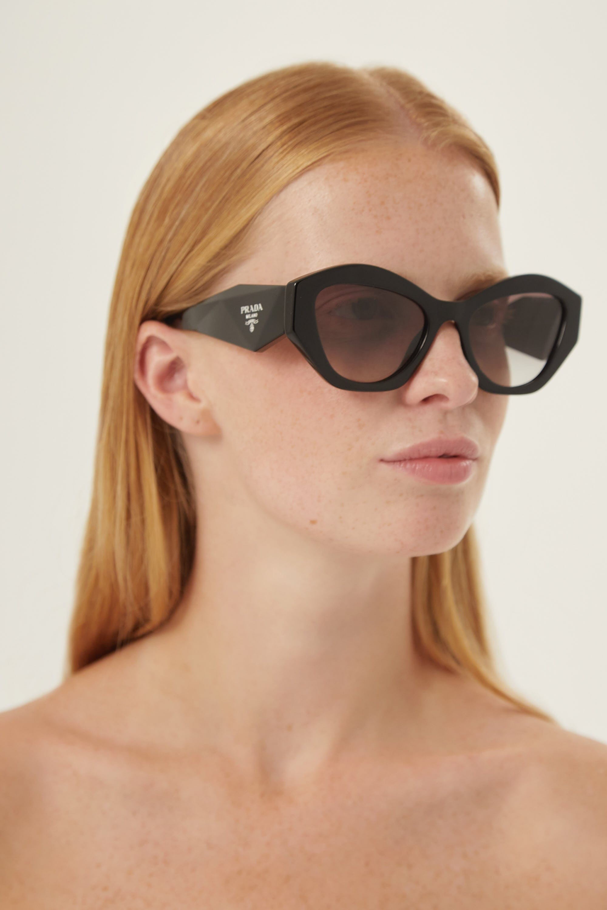 Prada oval black sunglasses featuring iconic logo