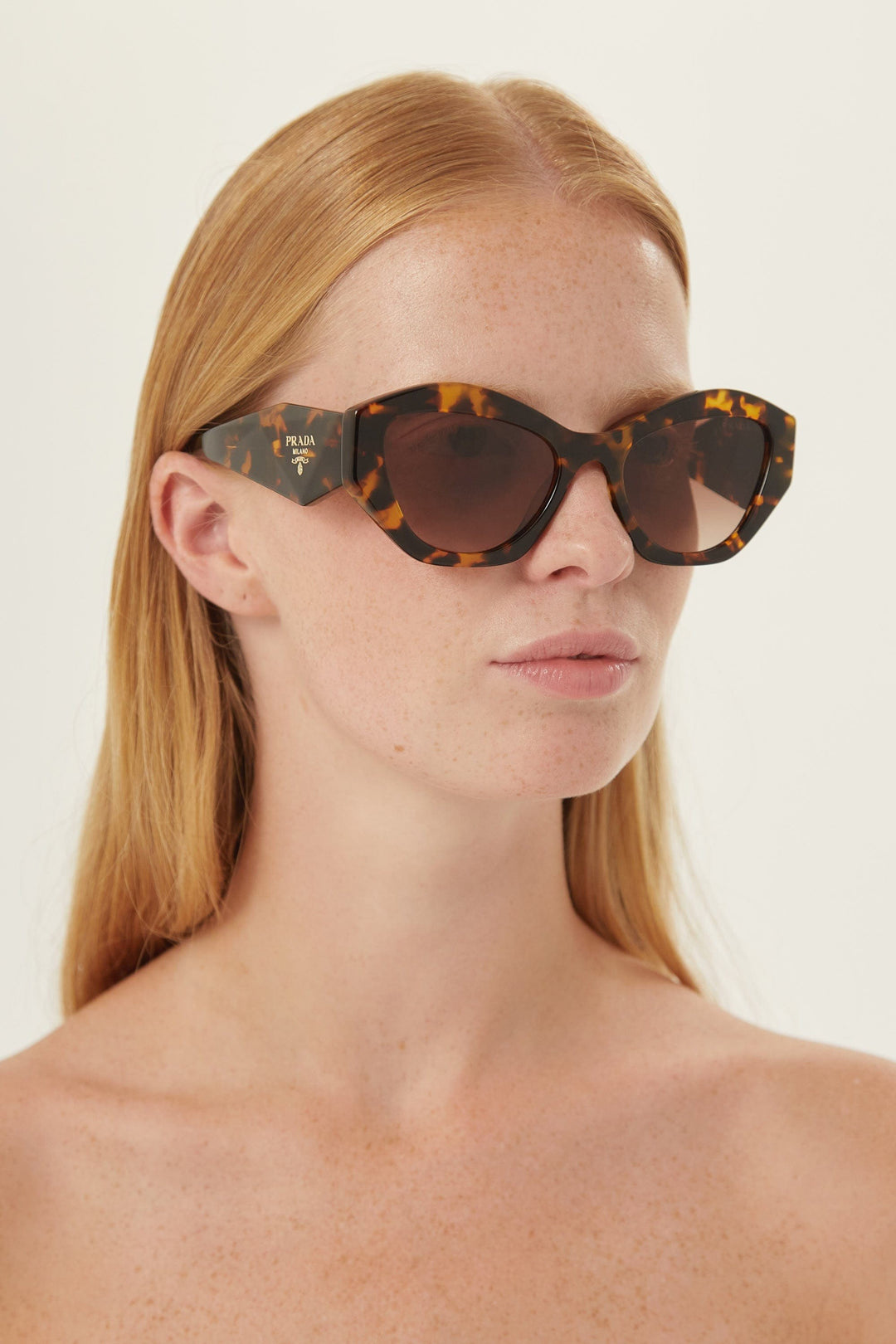 Prada oval sunglasses featuring iconic logo