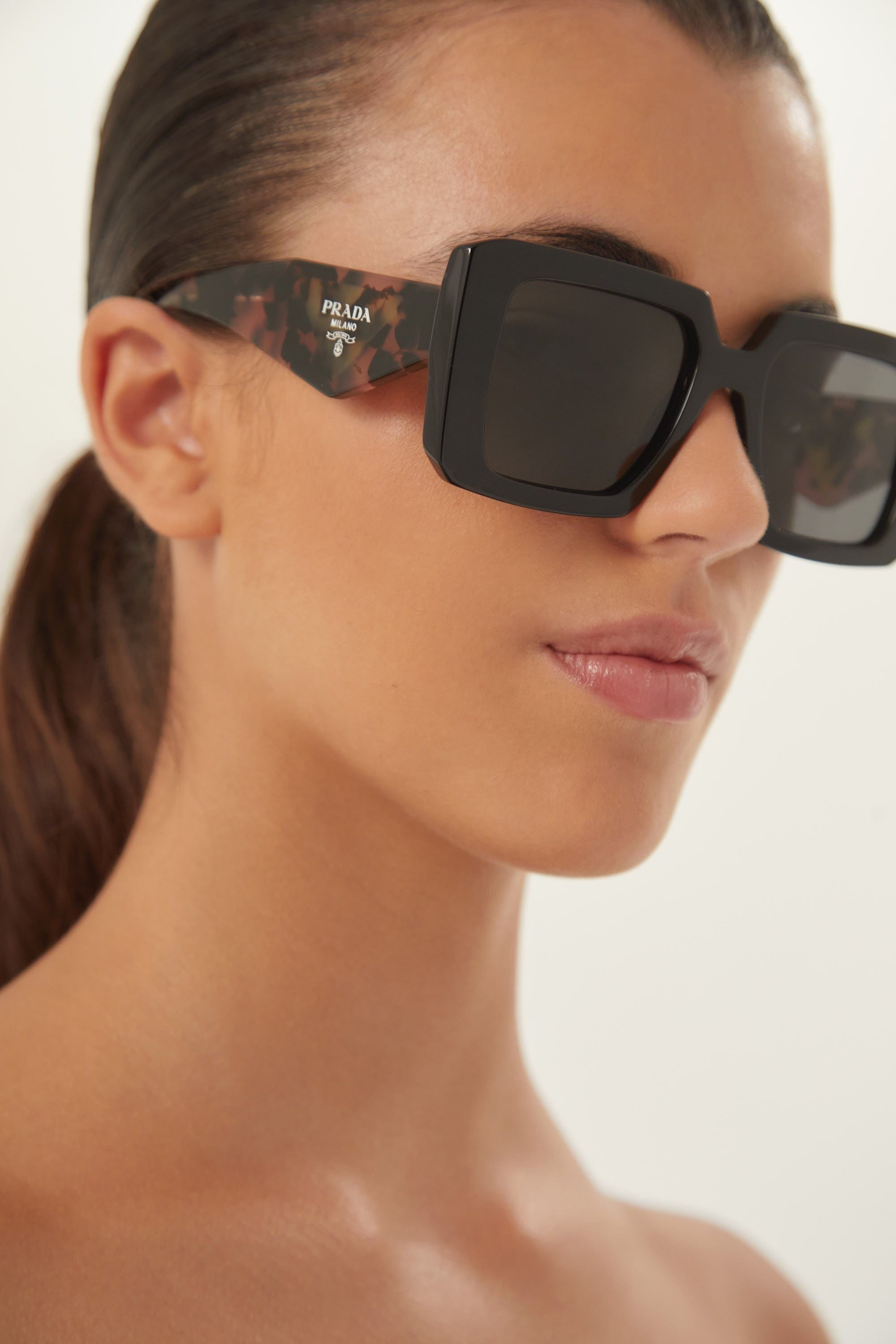 Prada squared sunglasses featuring the signature logo triangle Eyewear Club