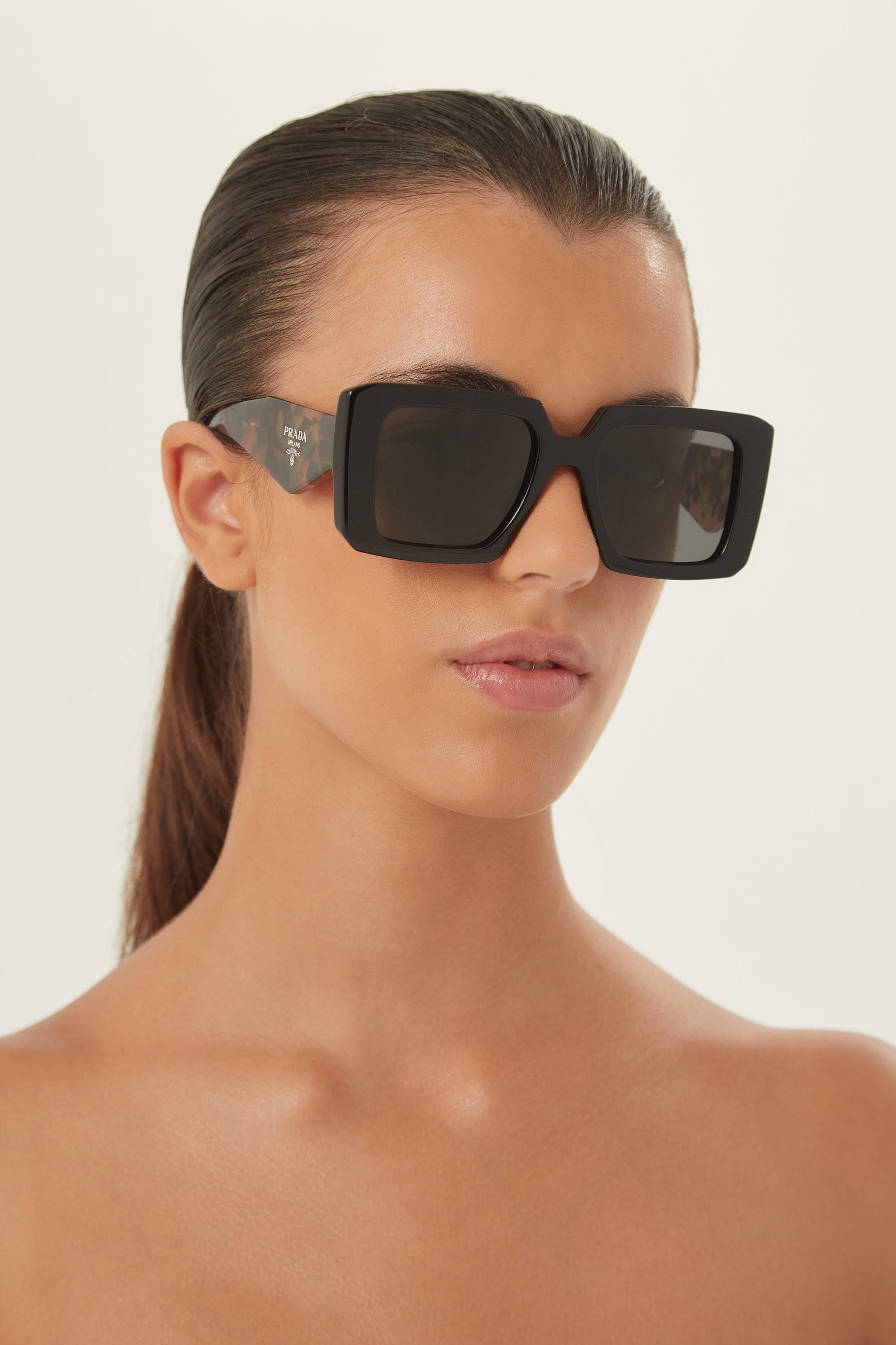 Prada squared sunglasses featuring the signature logo triangle